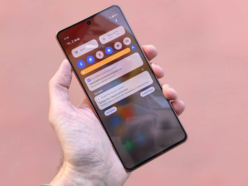 Hand holding a smartphone showing notifications